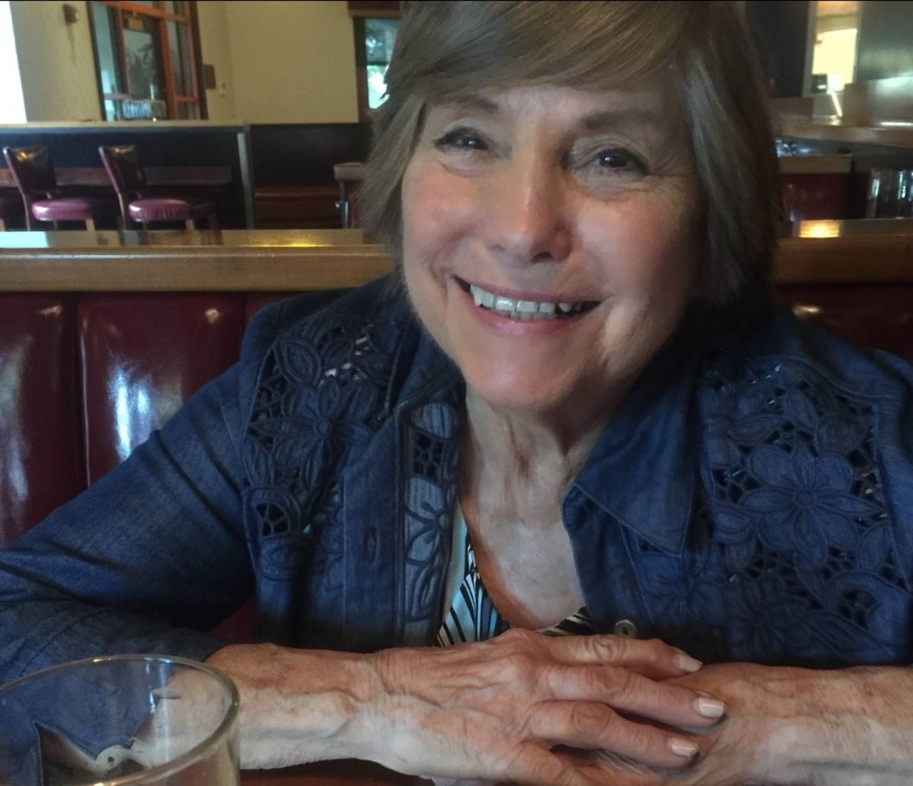 Regina LaBadie smiling at a restaurant